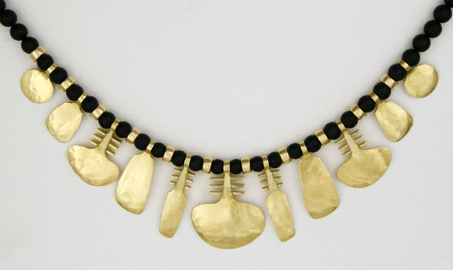 Large Symbol Necklace in 18K yellow gold with eleven motifs and gold spacers on black Agate beads